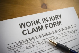 Work injury claim form and a pen on a desk.